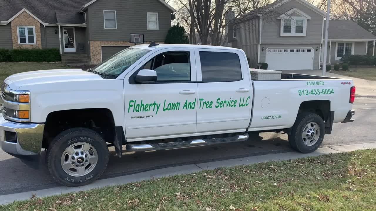 White Flaherty Lawn And Tree Service pickup parked on a residential street