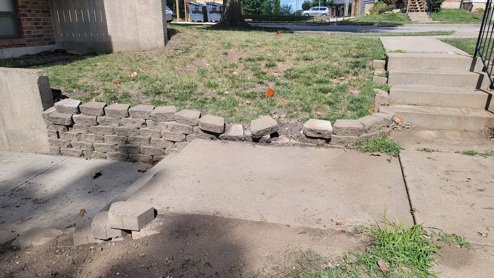 The old retaining wall before the job, pulled away from the walkway