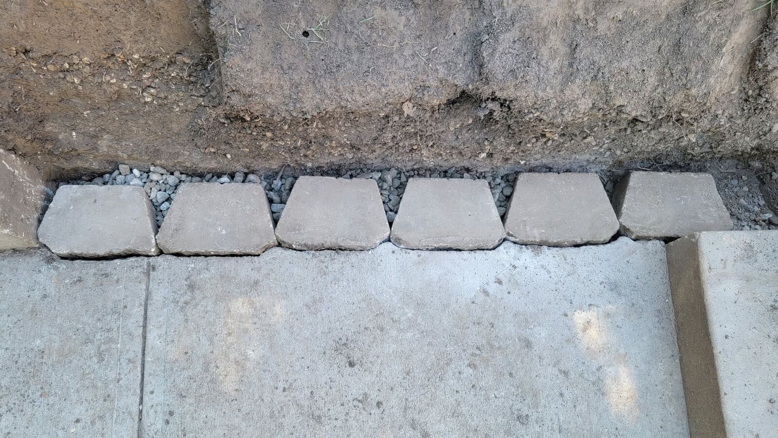First course of blocks set on gravel along the walk